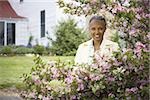 Portrait of a mature woman smiling behind flowers