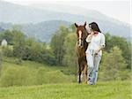 woman walking with a horse