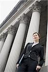 Low angle view of a female lawyer holding a file and smiling