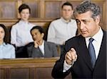 A male lawyer talking in a courtroom