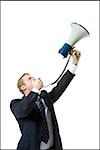 Businessman shouting into a megaphone