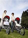 Low angle view of two mannequins portraying mothers pushing prams