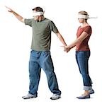 Blindfolded young man leading to a blindfolded young woman