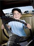 Young boy pretending to drive