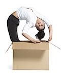 Female contortionist businesswoman inside cardboard box