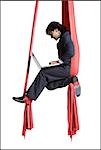 Businessman tangled in red drapes