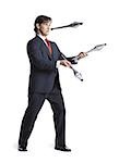 Businessman juggling pins