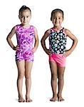 Two young female gymnasts with hands on hips