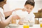 Father and young son having breakfast together