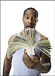 African American holding a pile of dollar bills