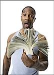 African American holding a pile of dollar bills