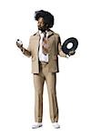 Man with an afro in beige suit listening to MP3 player