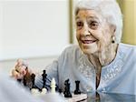 Elderly woman playing chess