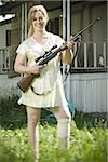 Woman in trailer park with a rifle