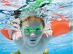 Boy swimming underwater in pool