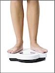 Bare feet standing on a scales. Lose weight concept with person on a scale  measuring kilograms. Weight Scale, Underweight man on Scale Stock Photo -  Alamy