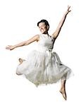 Woman in white dress jumping