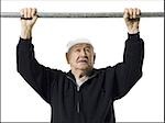 Older man doing chin up exercises