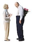 Older man giving wife bouquet of pink roses