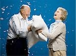 Older couple pillow fighting