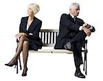 Businessman and businesswoman sitting on a bench