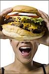 Woman eating a supersized hamburger