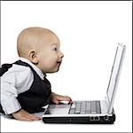 Baby boy in suit with laptop