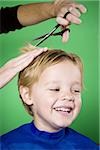 Boy having his hair cut smiling