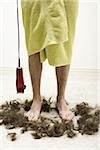 Man in bath towel with razor standing in hair