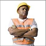 Male road worker with crossed arms and hardhat