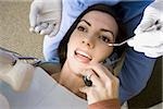 Woman with dental hygienist talking on cell phone