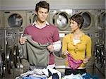 Couple folding laundry in Laundromat