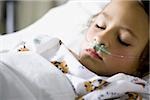 Young girl in hospital bed with respirator