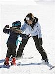 Woman and young girl skiing