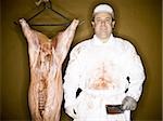 Butcher with hanging carcass and knife