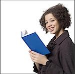 Girl with hardcover book and braces smiling