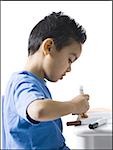 Boy sitting at table doing crafts