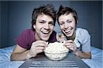 Couple eating popcorn and smiling