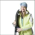 Girl with winter hat and skis smiling