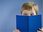 Boy reading book and smiling