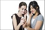 Two girls listening to mp3 player smiling