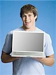 Boy with laptop smiling