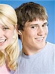 Portrait of a young couple with ear buds smiling