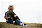 Boy with puppy outdoors