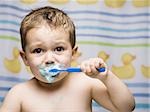 Boy brushing teeth in bathroom