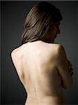 Rear view of topless woman with hands on lower back waist up - Stock Photo  - Masterfile - Premium Royalty-Free, Code: 640-01458754