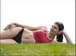 Woman in bikini lying down in grass