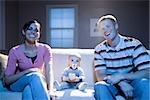 Couple on sofa with baby smiling