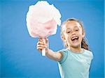 Girl holding cotton candy smiling