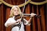 Girl playing violin on stage